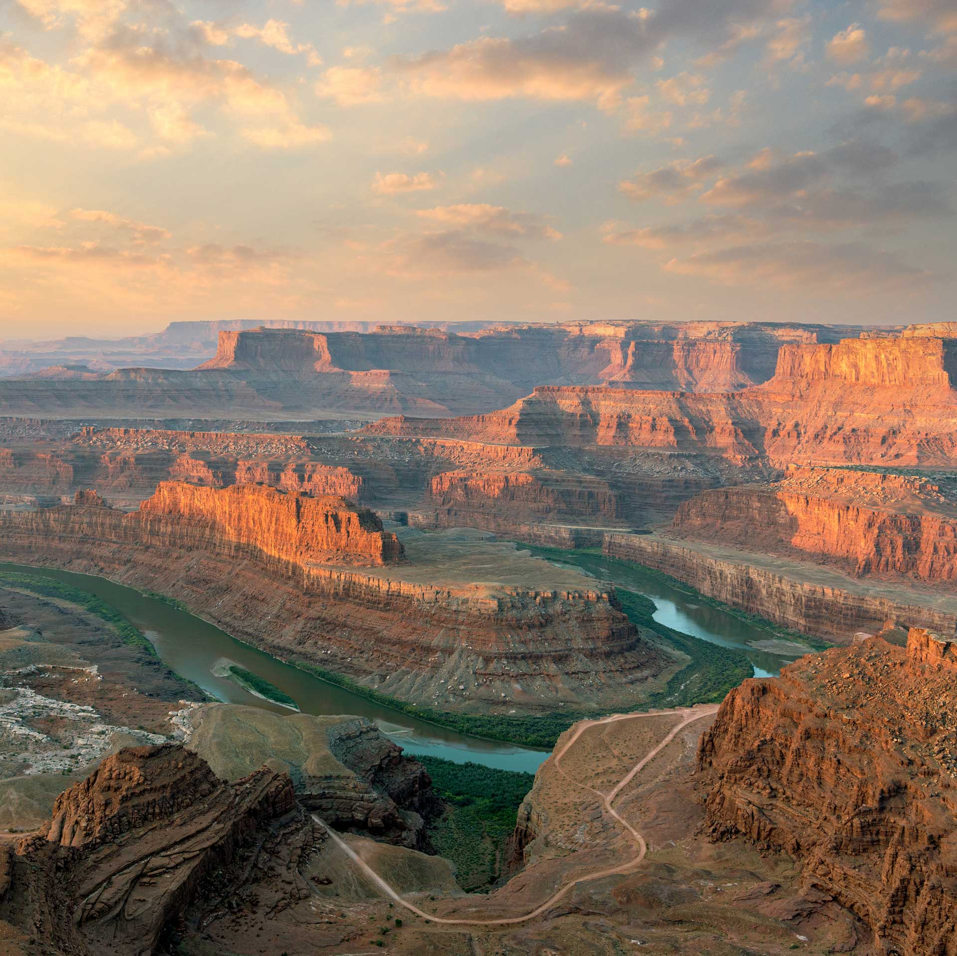 Canyon with a river running thru it at sunset.
