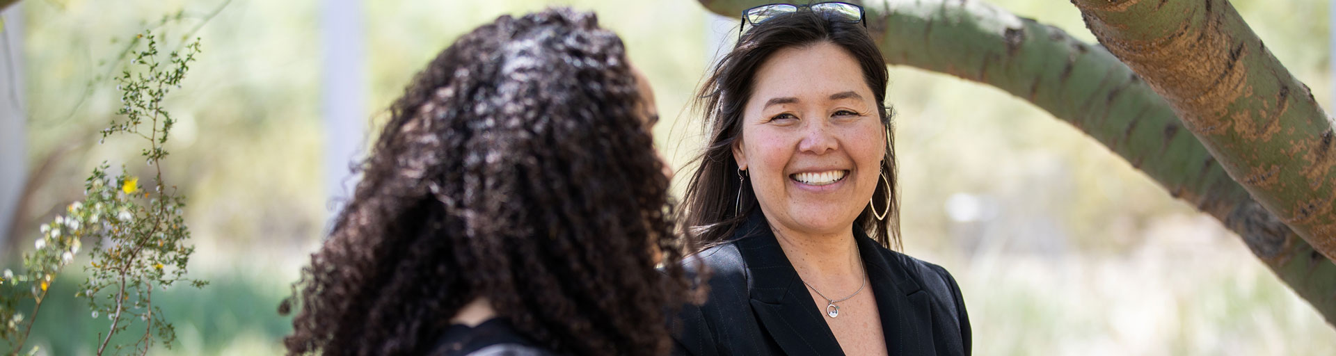 Arizona State University President’s Professor Sharon Hall talking with a student in nature